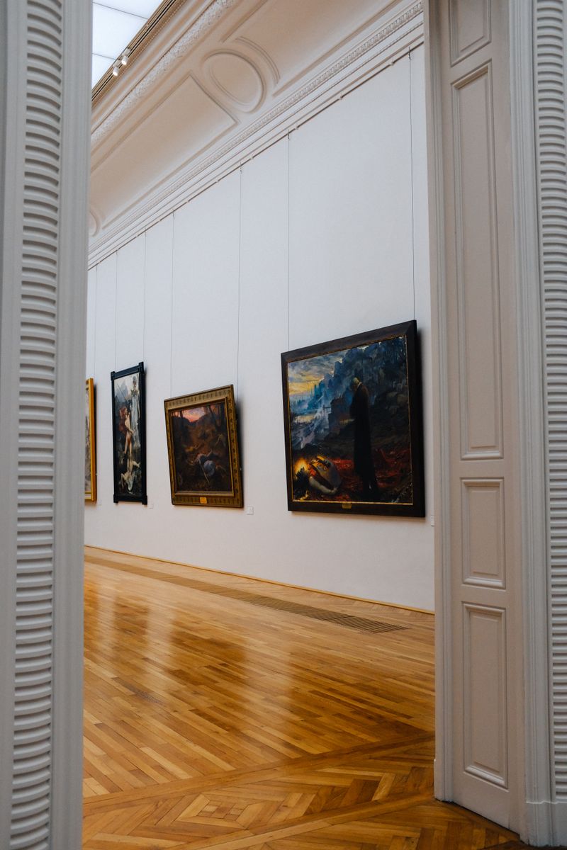 A gallery wall hung with framed original paintings